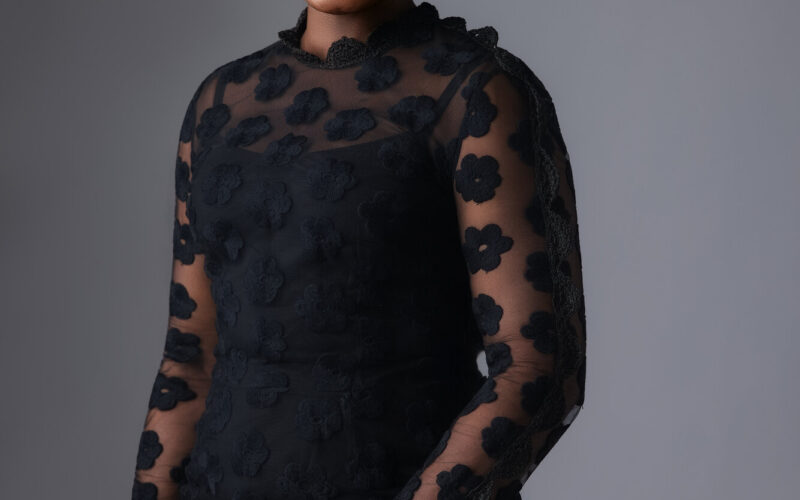 Dr. Adaeze Oreh — Standing portrait in black floral dress