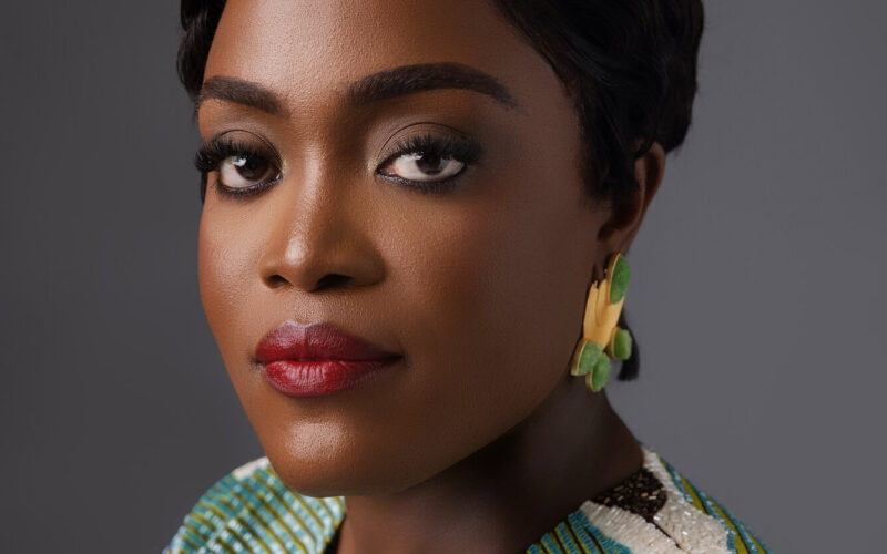 Dr. Adaeze Oreh — Studio portrait in colorful striped top