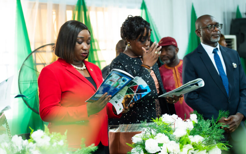 Dr. Adaeze Oreh — Reviewing event brochure at formal gathering