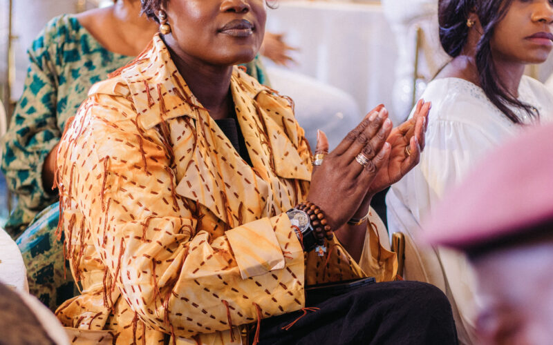 Dr. Adaeze Oreh applauding at a formal ceremony