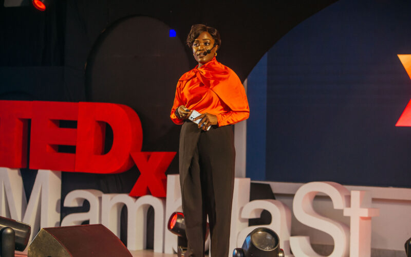 Dr. Adaeze Oreh speaking on stage at a TEDx event